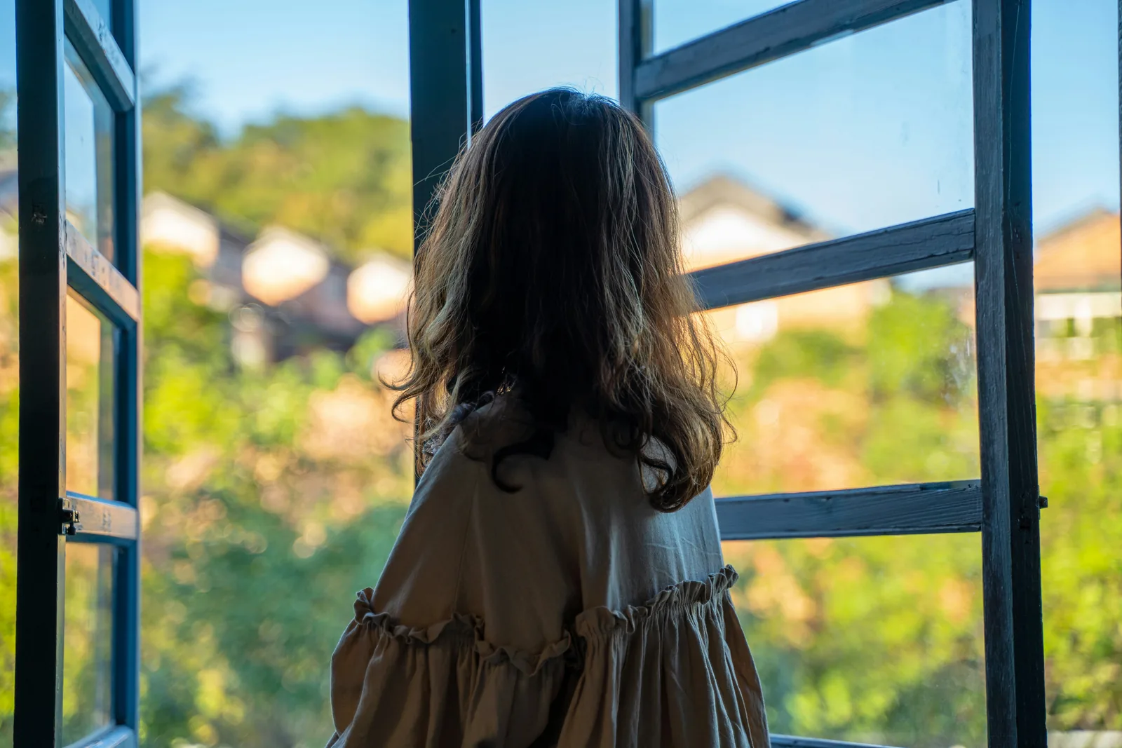 A woman looking out at a garden
